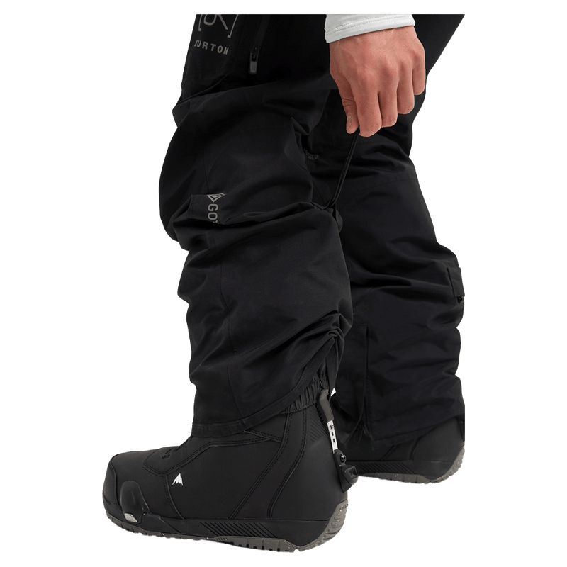 Detailed cropped view of a man wearing the Burton AK Swash Gore-Tex 2L Snowboard Pants in black
