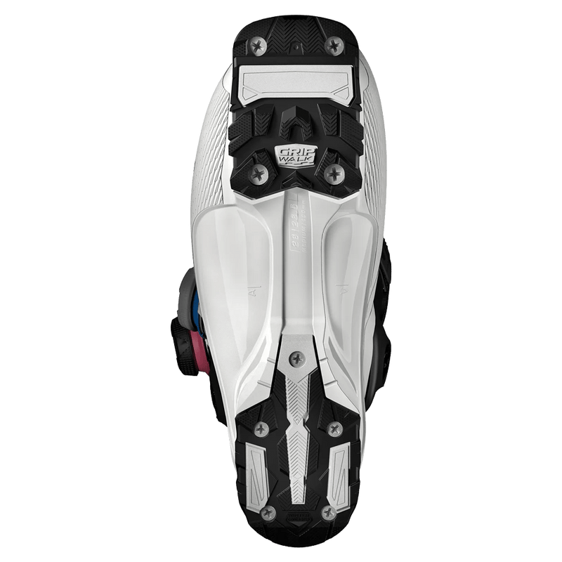 Bottom view of white Salomon S/Pro Supra Dual Boa 130 ski boot showing black and white GripWalk soles.