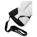 Close-up of white leather Hestra glove cuff with black fabric, elastic wrist, and a black Hestra branded wrist strap.