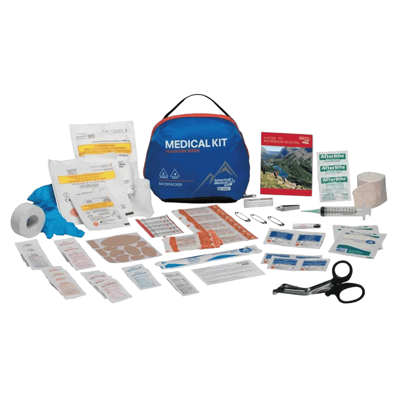 Adventure Medical Backpacker Kit showing all the contents laid out. Zissors, medications, wound care, blister care, safety pins, manual, tape, gloves, sanitary wipes etc.