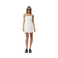 White Afends Lilo strapless mini dress on a woman with black platform sandals and sunglasses.