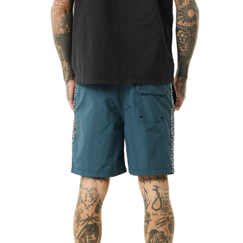 Back view of man wearing Afends Sixsixsix Recycled Baywatch Shorts in fuel colorway