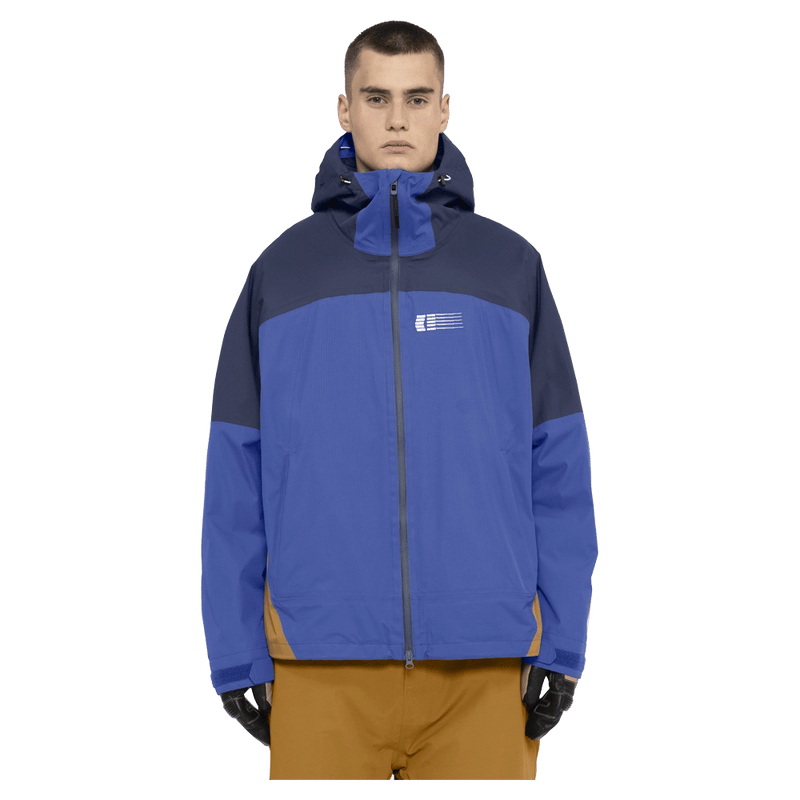 Front view of the Armade Ansel 2L Shell Jacket in Dazzler, Navy and Golden Brown colourway, unisex's model