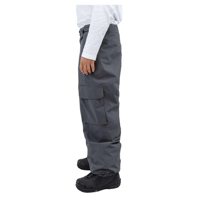 Side view of Beyond Medals dark grey cargo snowboard pants featuring a large side pocket and elasticated leg cuffs.