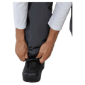 Hands adjusting the elasticated boot gaiter of grey Beyond Medals Cargo 2L Snowboard Pants over a black boot.