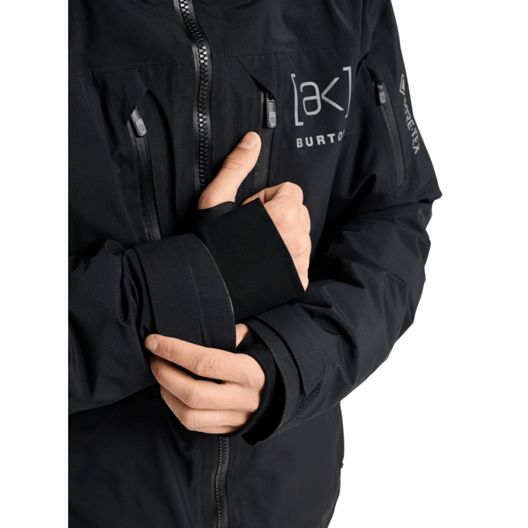 Black Burton AK Lz Gore-Tex 2L Down Snowboard Jacket with waterproof zippers, chest logo, and thumbhole wrist gaiters.