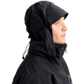 Side profile of a black Burton AK Lz Gore-Tex jacket with an adjustable hood, brim, and high collar.