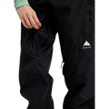Close-up of black Burton Reserve Bib Snowboard Pants for women with a zippered thigh vent and white mountain logo.