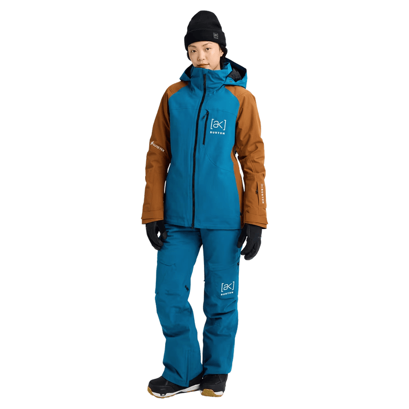 Full-body view of the Burton AK Embark Snowboard Jacket in Blue Teal and Chestnut colourway, women's model