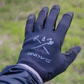 Dakine Covert bike glove featuring a tan and grey camouflage mesh back, black accents, and Dakine logo on the finger.