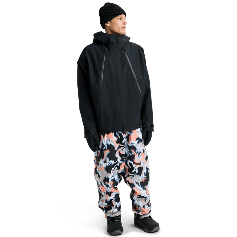 Black Burton Futuretrust 3L Snowboard Jacket with large diagonal zippers and hood, worn by a model in a full-body view.