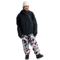 Black Burton Futuretrust 3L Snowboard Jacket with hood and oversized fit, worn with a white beanie and patterned pants.