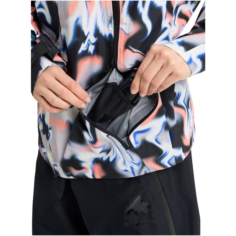 Burton Futuretrust 3L Snowboard Jacket in blue and peach marble print with a hand reaching into a zippered chest pocket.