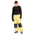 Yellow Volcom Longo Gore-Tex Snowboard Pants with black knee patches and elastic cuffs worn by a model.