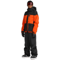 Black Volcom Kleveland snowboard pants with a relaxed fit, worn by a model in an orange and black jacket.