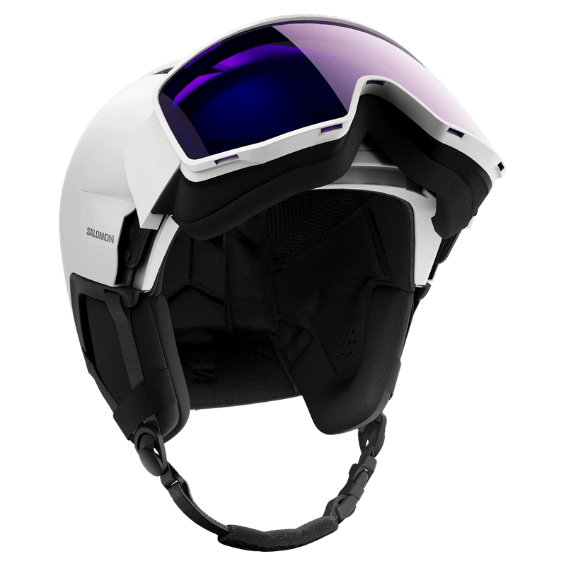 White Salomon Driver Pro Sigma Photo MIPS ski helmet with integrated purple visor and black padding, low angle view.