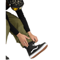 Olive green Volcom Longo Gore-Tex snowboard pants with adjustable elastic ankle gaiters over black high-top boots.