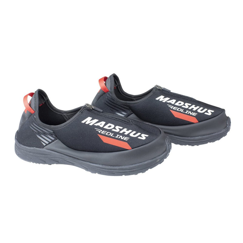 A pair of Madshus Overboots with a hard black rubber sole and wetsuit type material. Zipper opening and White and Red lettering and branding