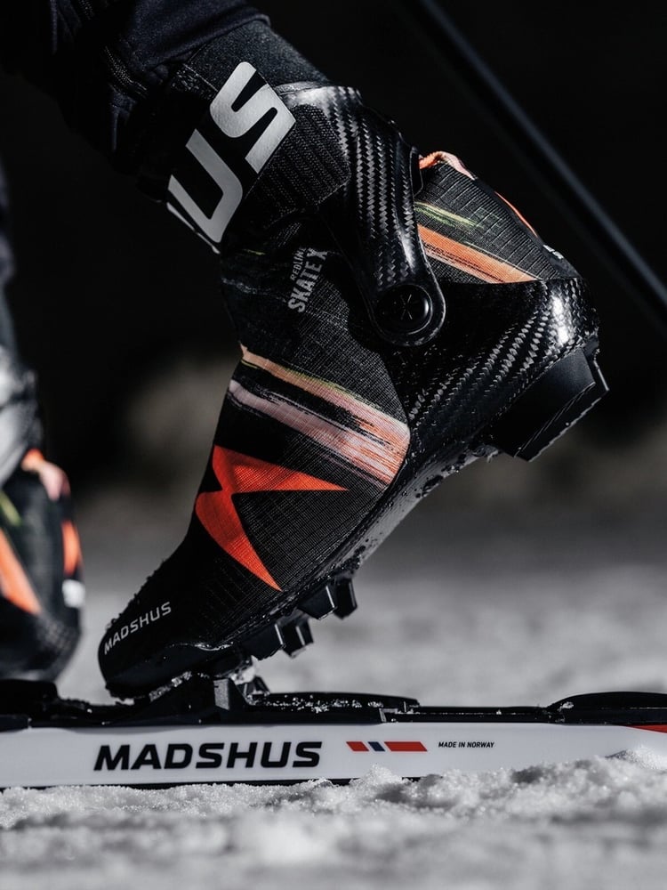 Model foot on ski showing the Madshus Redline Skate X cross country boot attached to the binding