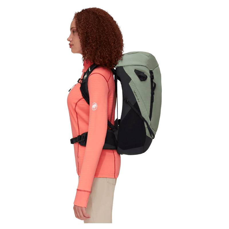 Carried side view of the Mammut Ducan 24 Backpack in Jade Black colourway, women model