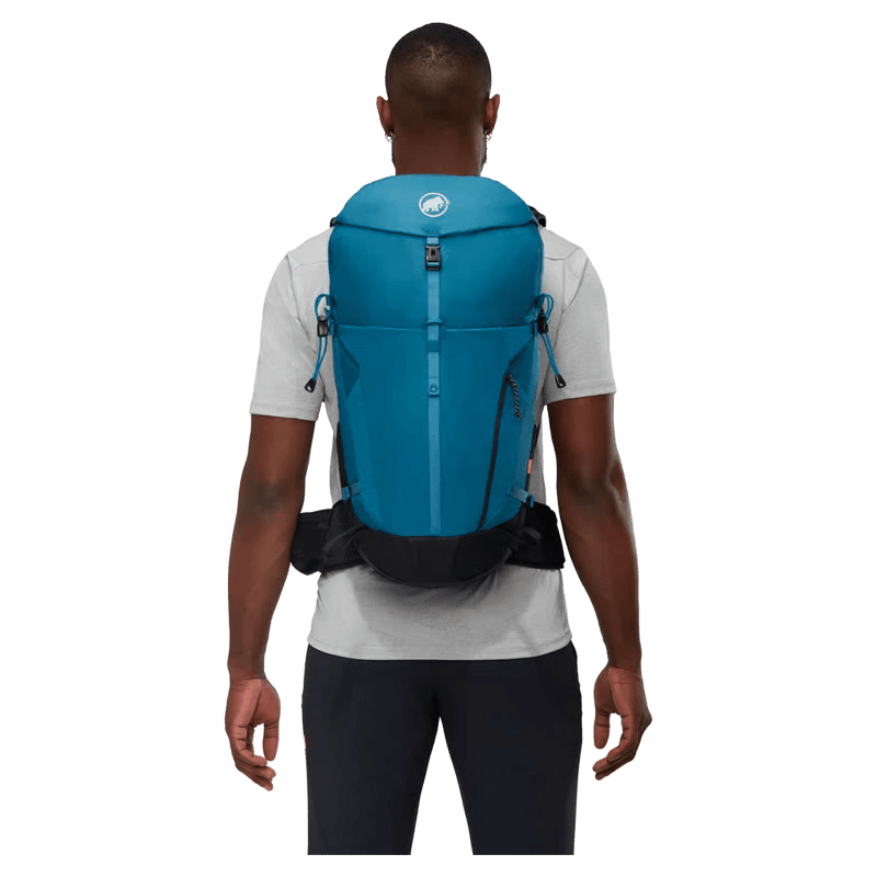 Carried view of the Mamut Lithium 30L Backpack in Sapphire Black colourway, unisex's model