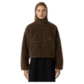 View of a woman wearing The North Face Extreme Pile 2 Pullover for Women in Smokey Brown featuring a half front zip, zip chest pocket, side pockets and adjustable hem, with a small side embroidered logo on the left chest.