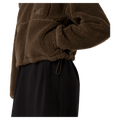 View of a woman wearing The North Face Extreme Pile 2 Pullover for Women in Smokey Brown featuring side pockets and an adjustable hem