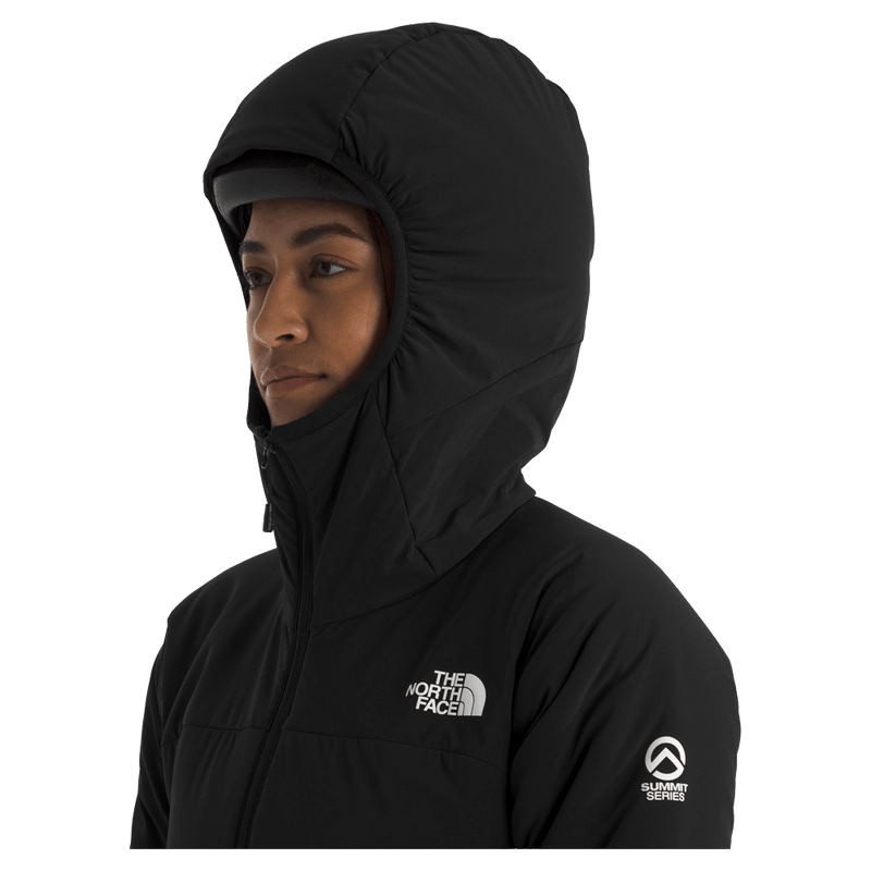 View of a woman wearing The North Face Summit Casaval Hybrid Hoodie in black, wearing the adjustable helmet compatible hood