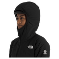 View of a woman wearing The North Face Summit Casaval Hybrid Hoodie in black, wearing the adjustable helmet compatible hood