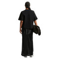 Back view of the Nike Classic Tee in Black colourway, women model
