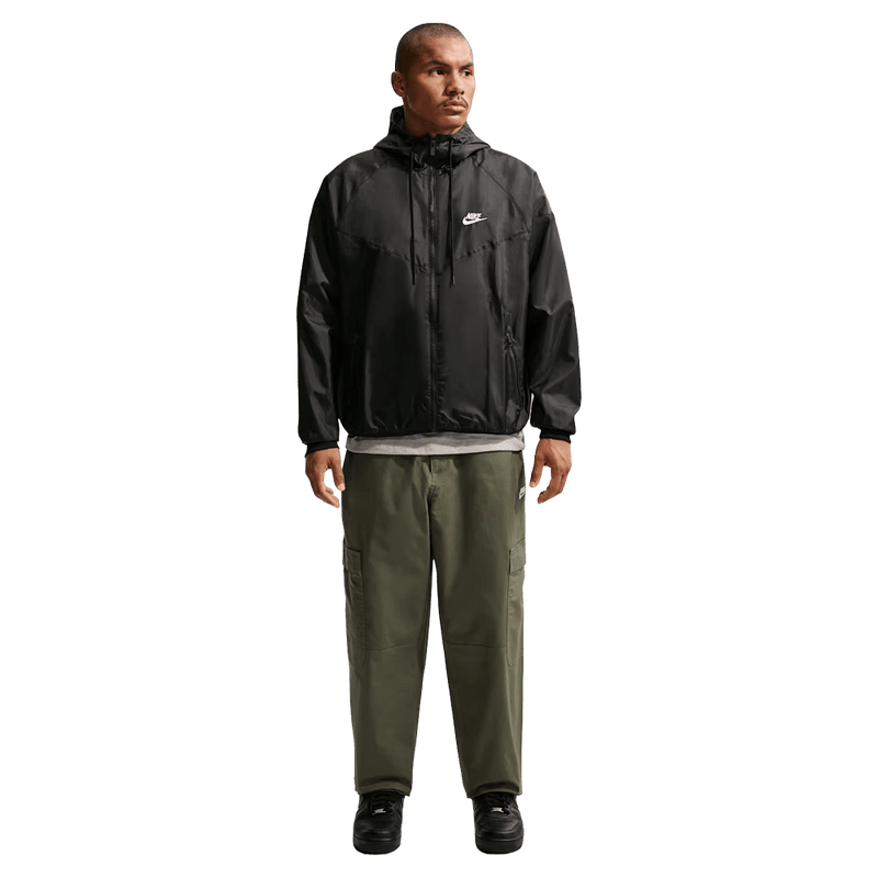 Front view of the Nike Club Cargo Pants in Olive colourway, unisex model
