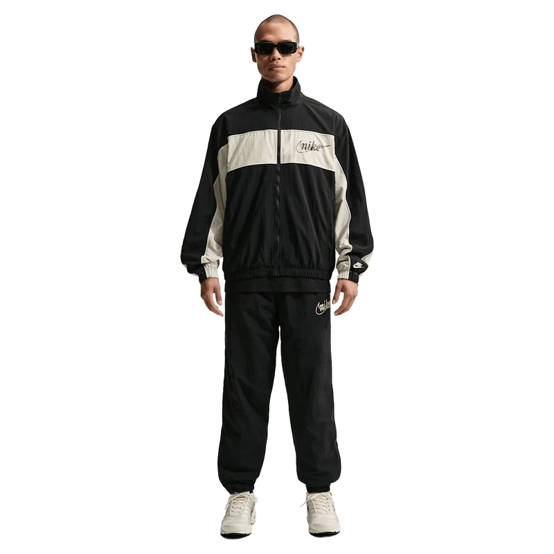 Front view of the Nike Club Lightweight Pants in Black and Khaki colourway, men model