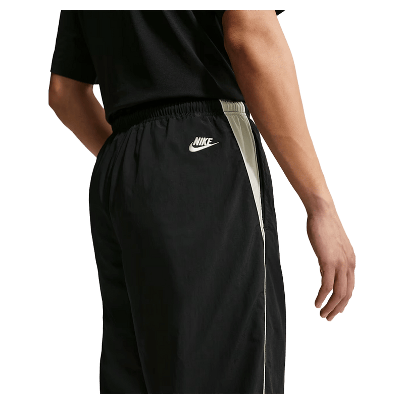 Detail view of the Nike Club Lightweight Pants in Black and Khaki colourway, men model