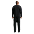Back view of the Nike Club Track Pants in Black and White colourway, unisex model