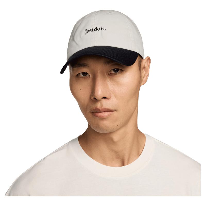 Front view of the Nike Club Cap in Sail and Black colourway, unisex model