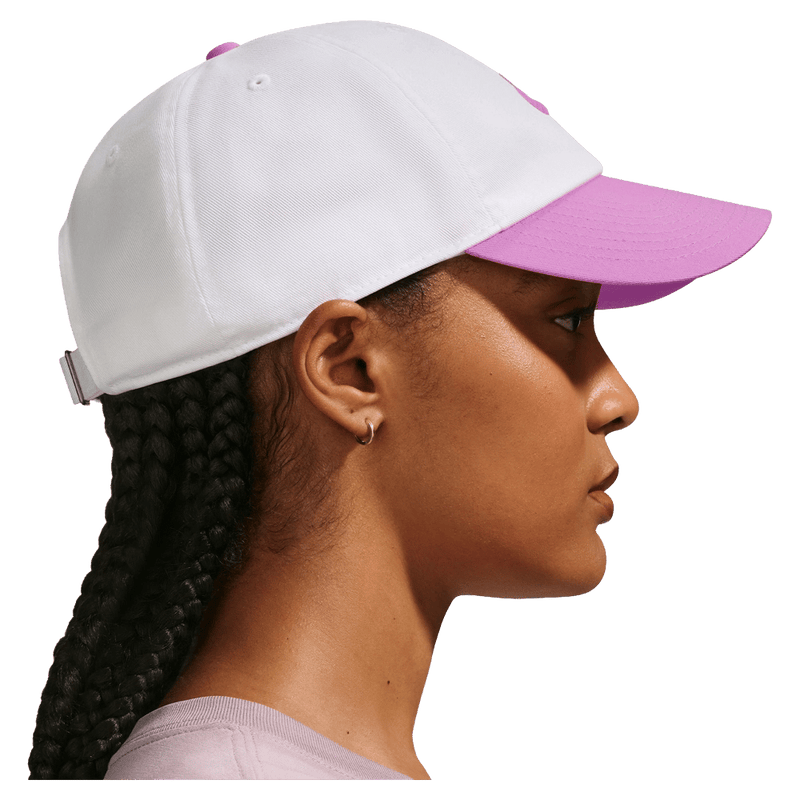 Side view of the Nike Club Cap in White and Lt Magenta colourway, unisex model