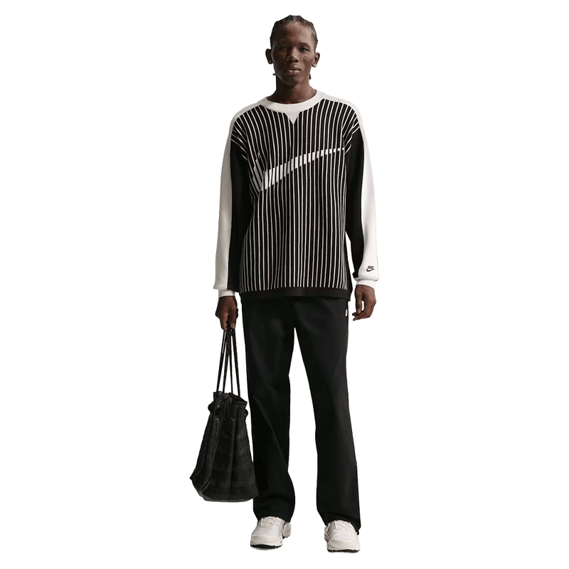 Front view of the Nike Club Pants in Black colourway, unisex model