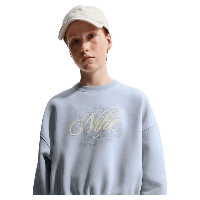 Main view of the Nike Sportswear Club Fleece Crew Neck in Ghost colourway, kids model