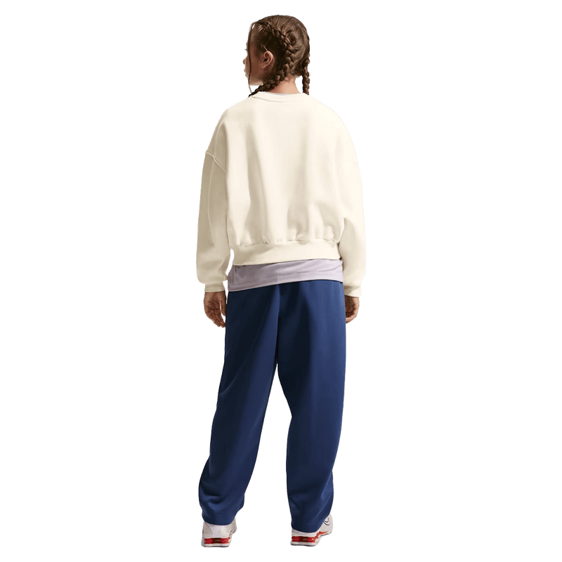 Back view of the Nike Sportswear Club Fleece Crew Neck in Soft Pearl colourway, kids model
