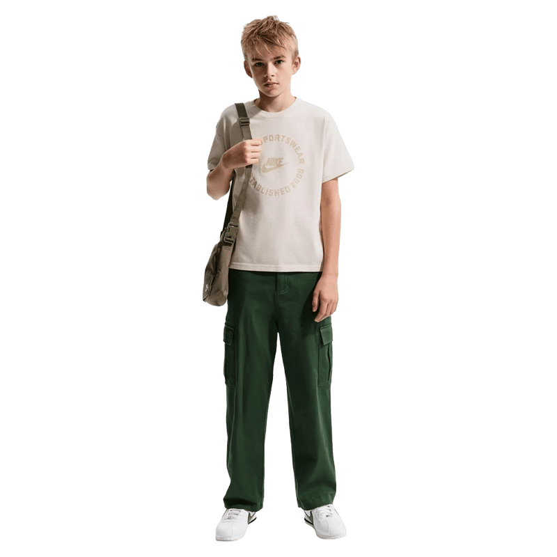 Front view of the Nike Sportswear Tee in Light Orewood Brown colourway, kids model