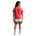 Back view of the Nike Sportswear Tee in Turf Orange colourway, kids model