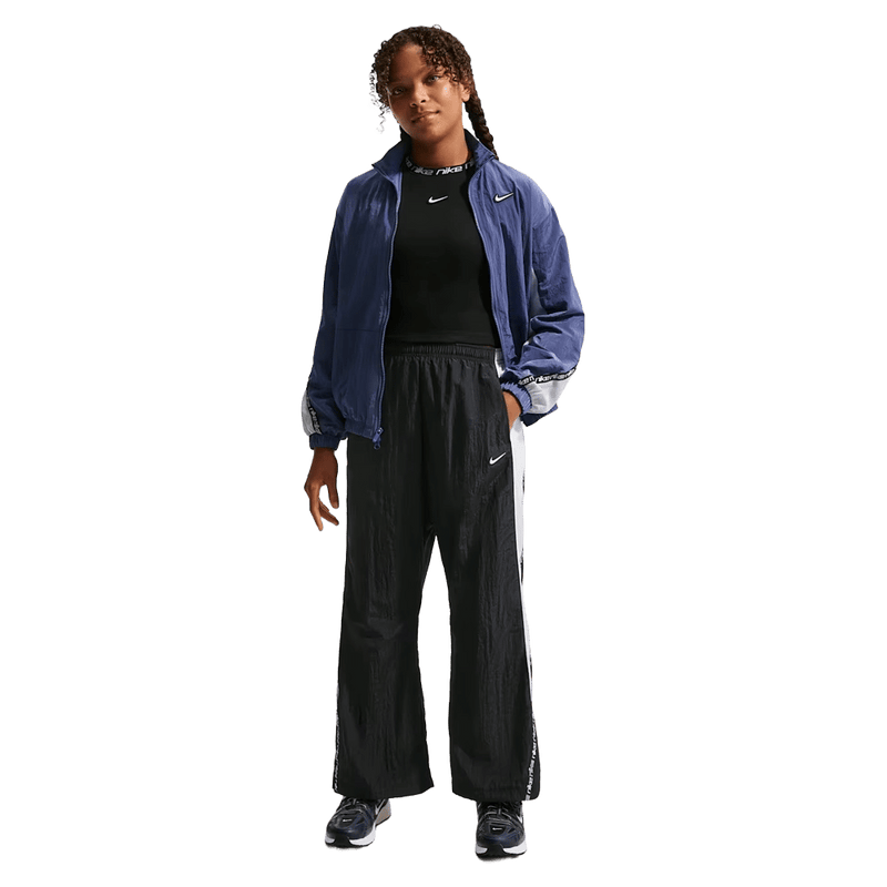 Front view of the Nike Sportwear Pants in Black colourway, kids model