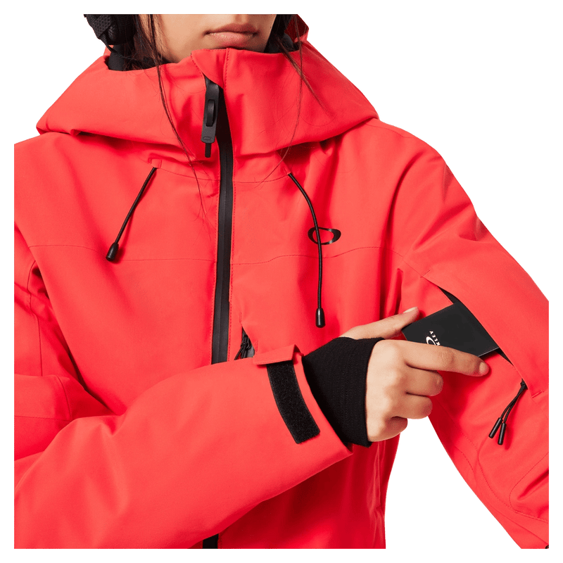 Pass pocket view of the Oakley Canopy Insulated Jacket in HIBISCUS RED colourway, women model