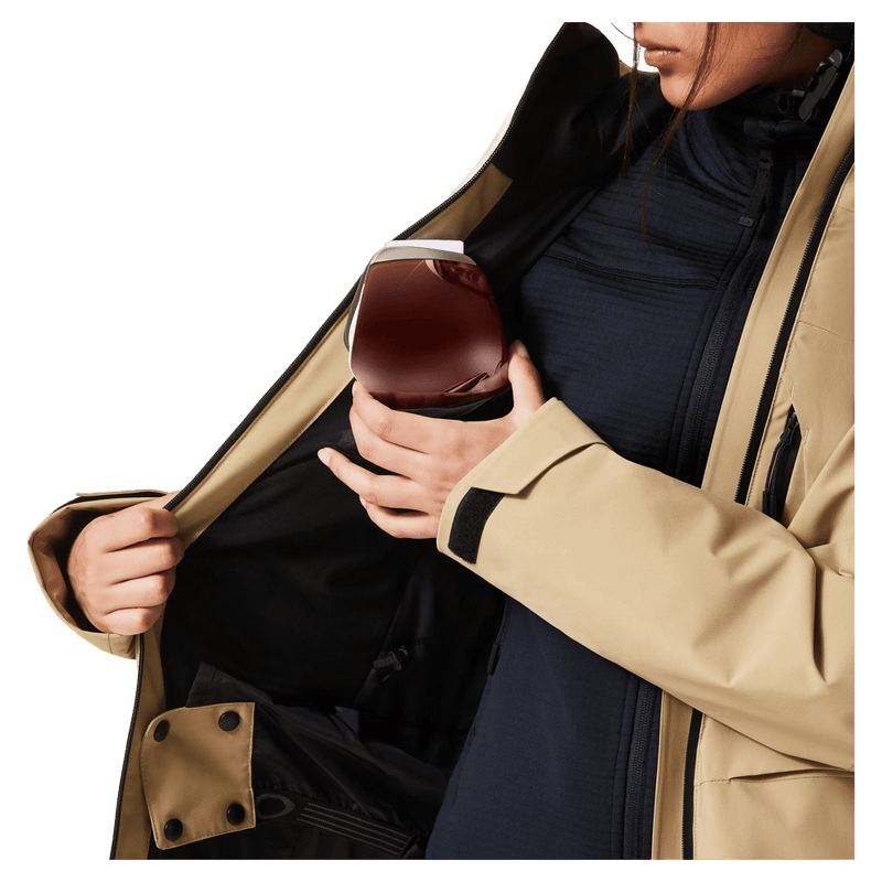 Goggle pocket view of the Oakley Canopy Insulated Jacket in Pebble colourway, women model