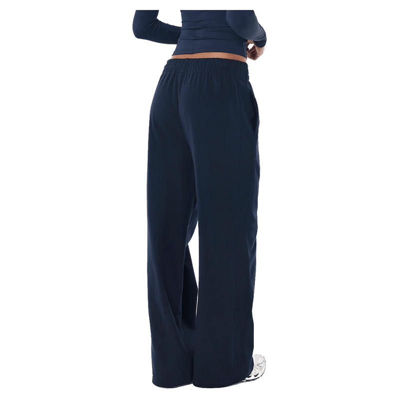 Back view of the P.E Nation Legacy Trackpant in Dark Navy colourway, women model