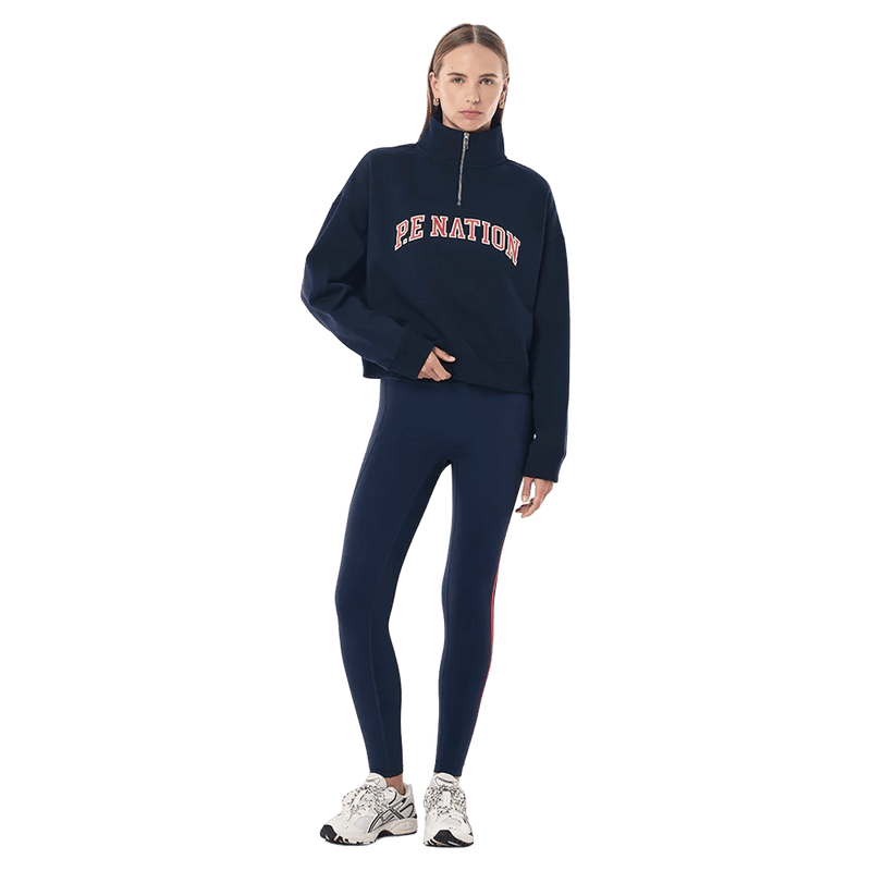 Full-body view of the P.E Nation Legacy Quarter Zip Jumper in Dark Navy colourway, women model