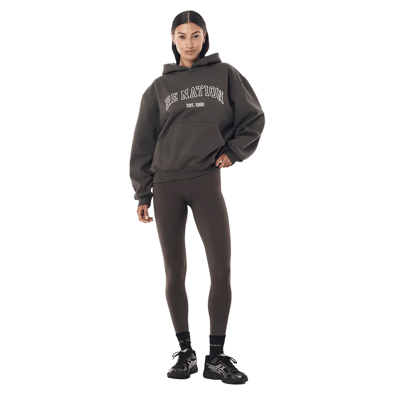 Full-body view of the P.E Nation Core Hoodie in Dark Olive colourway, women model