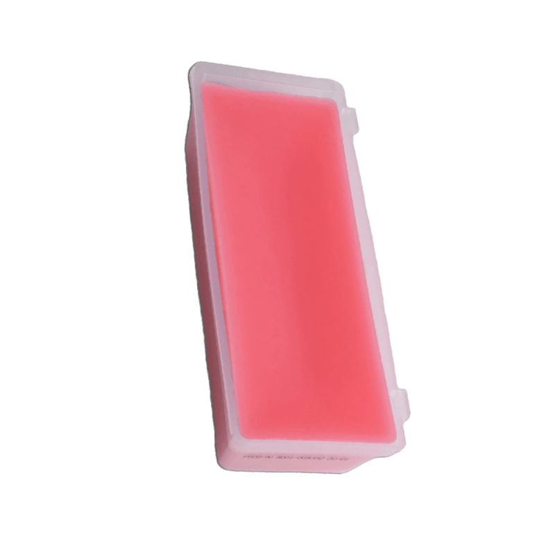 Red Swix PS 8 Fluor Free Glide Wax bulk block in a rectangular plastic tray, angled view.