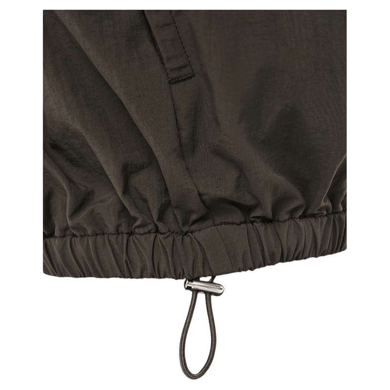 Close-up of the adjustable drawstring hem with a silver toggle on the Coffee P.E Nation Radius Jacket.