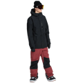 Front, on-body image of the Rain Gore-Tex Bib Snowboard Pants from Volcom in Burnt Red paired with jacket.